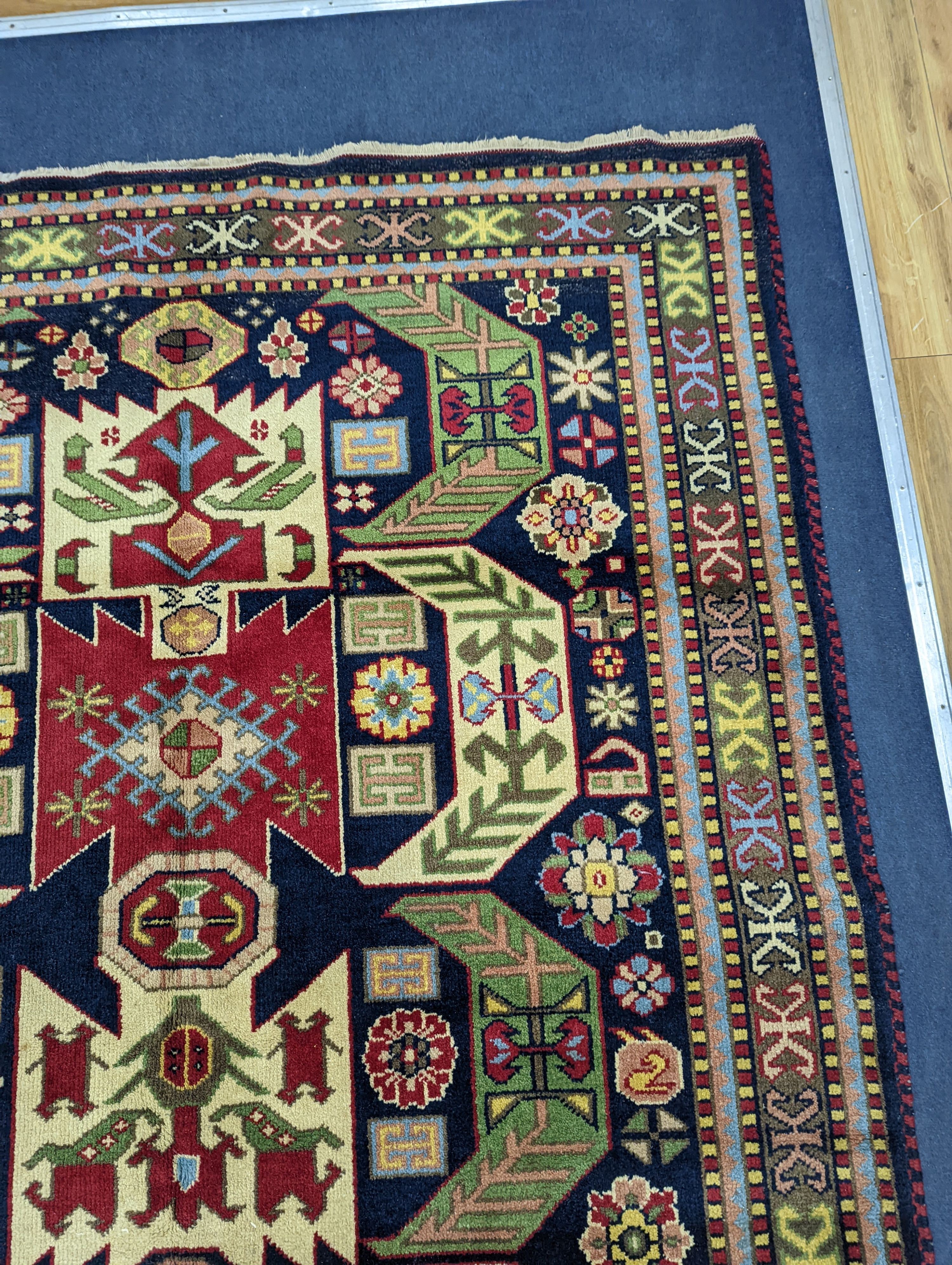 A Caucasian blue ground rug, 240 x 176cm